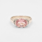 A close-up view of a vibrant sunset over a peaceful lake, reflecting warm colors in the water.