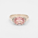 A close-up view of a vibrant sunset over a peaceful lake, reflecting warm colors in the water.