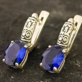 Created Sapphire Earrings made in 925 Sterling Silver with Oval Created Blue Sapphire in Prong setting, September Birthstone gift idea, symbolizes sincerity, truth, and faithfulness, ideal for everyday wear and perfect for birthday gifting and special occasions.