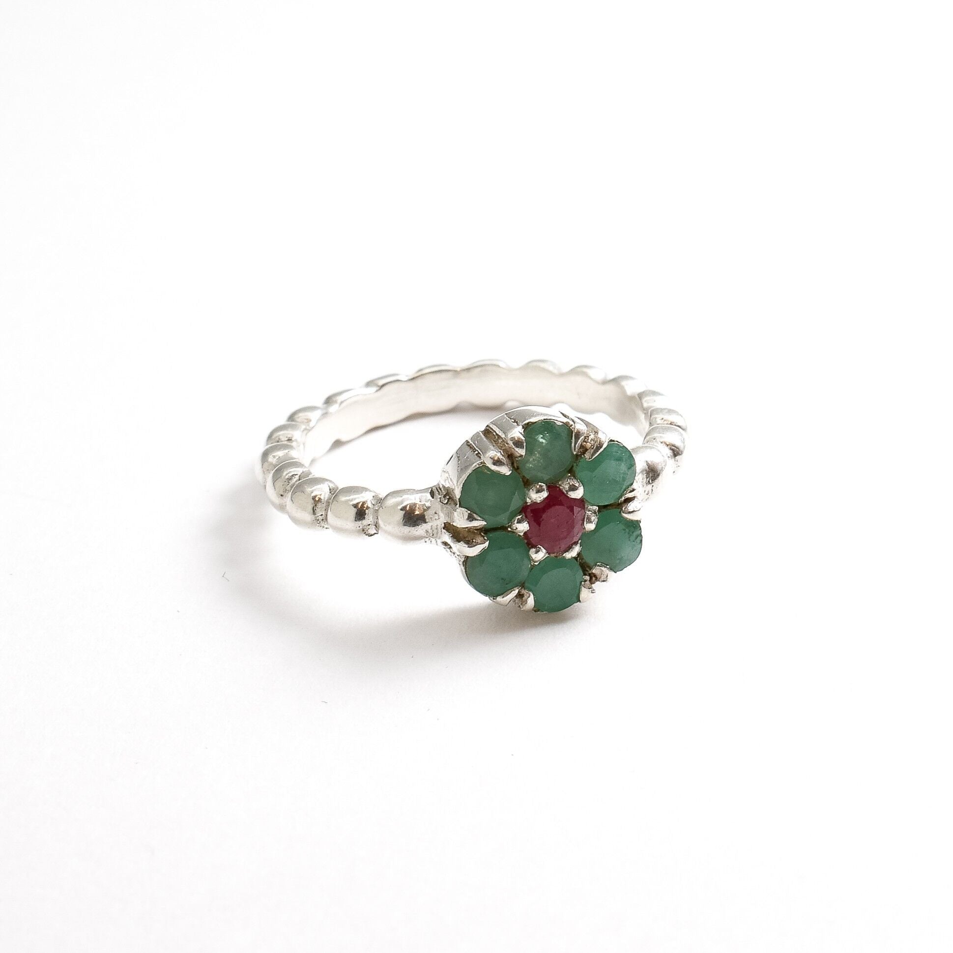 Stylish 925 Sterling Silver ring showcasing a stunning round emerald, a beautiful symbol of growth and emotional healing.