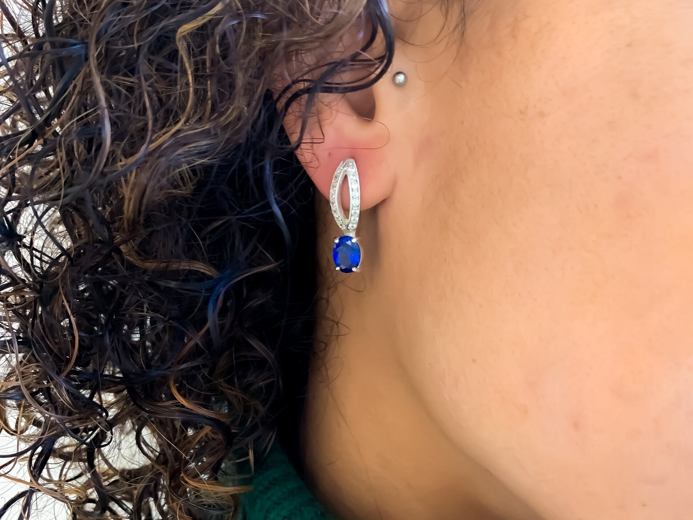 Sapphire earrings in sterling silver featuring oval blue sapphire, ideal for birthday gifts and everyday elegance.