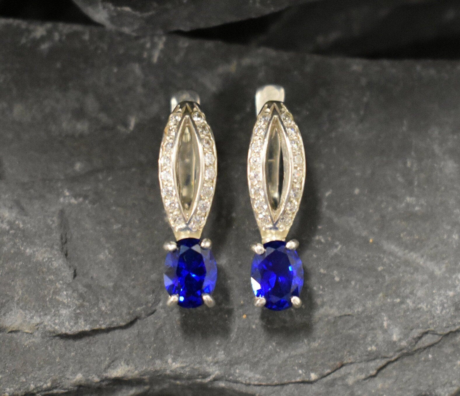 Created Sapphire Earrings made in 925 Sterling Silver with Oval Created Blue Sapphire in Solitaire with Accents setting, September Birthstone gift idea, symbolizes sincerity, truth, and faithfulness, ideal for everyday wear and perfect for birthday gifting and special occasions.