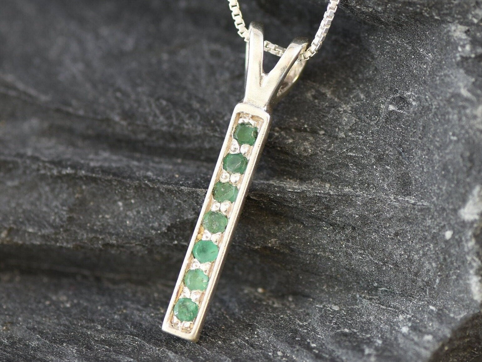 Elegant 925 Sterling Silver Natural Emerald Pendant with Channel-Set Round Emerald, symbolizes growth and harmony, ideal for gifts.