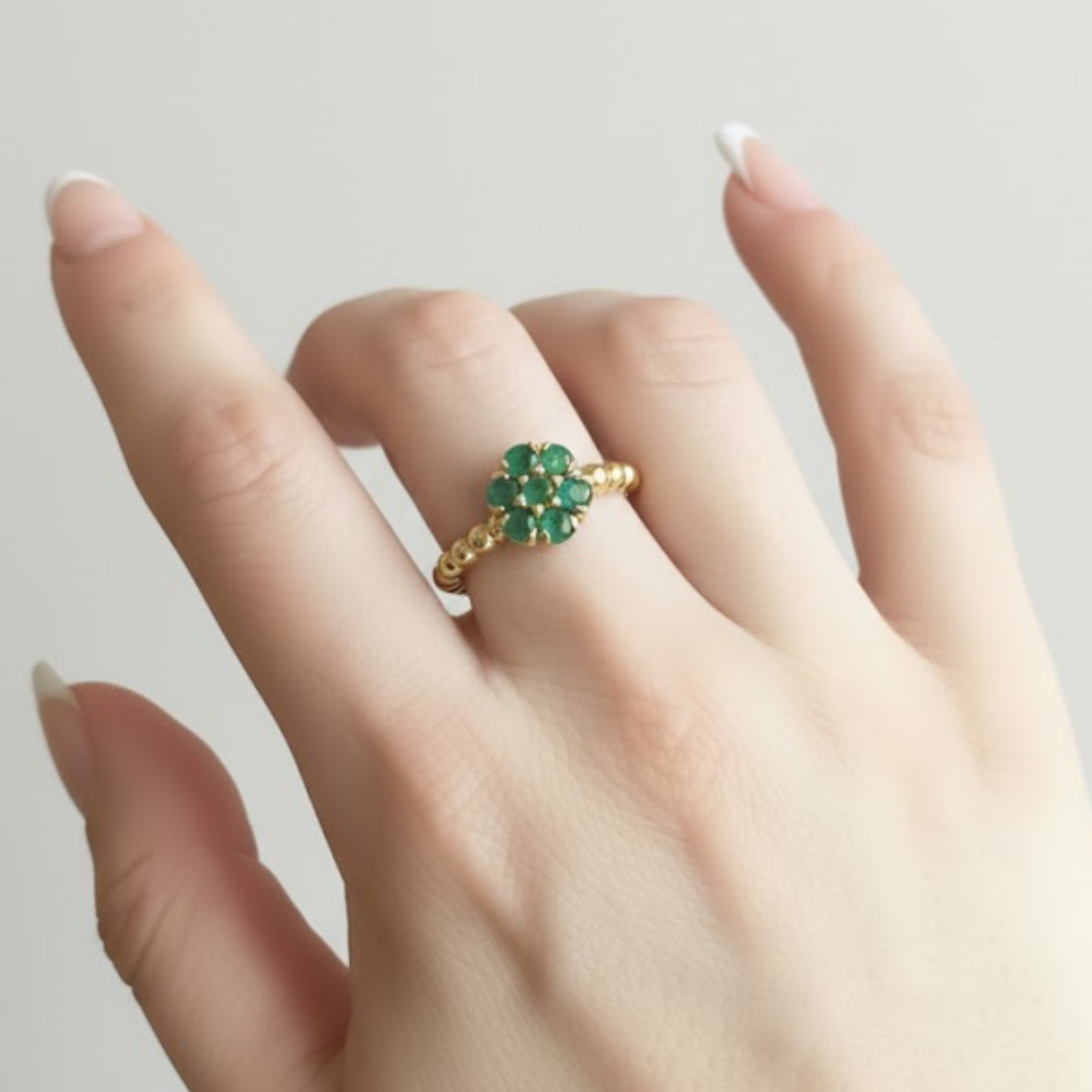 Elegant 18k Gold Vermeil ring featuring a cluster of Natural Green Emeralds, perfect for May birthdays and special occasions.