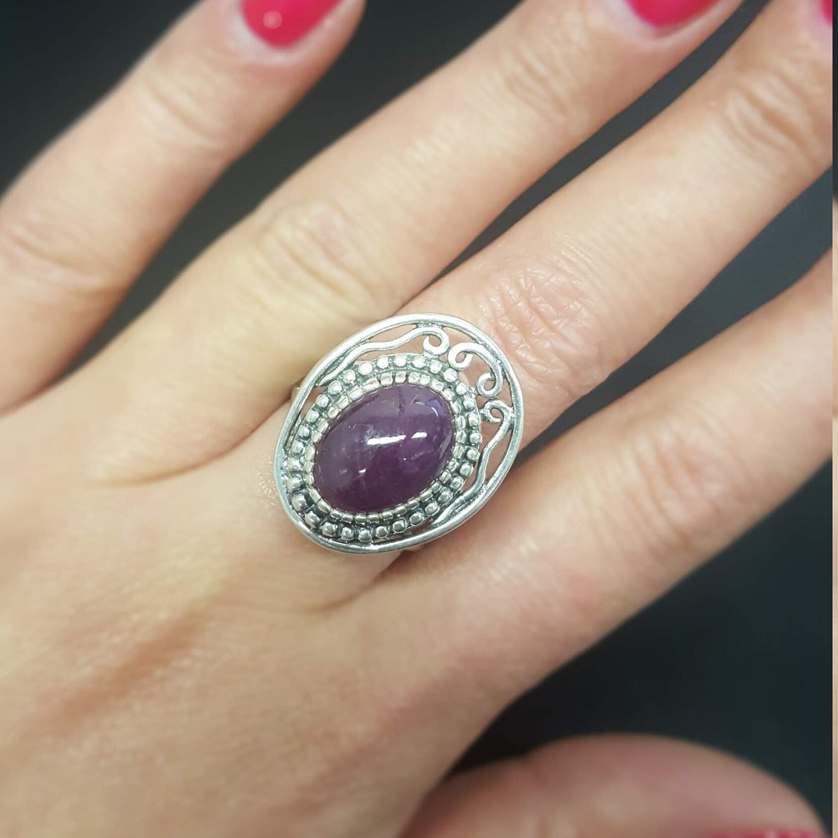Elegant 925 Sterling Silver ring featuring a stunning oval red ruby in a halo setting, perfect for special occasions.