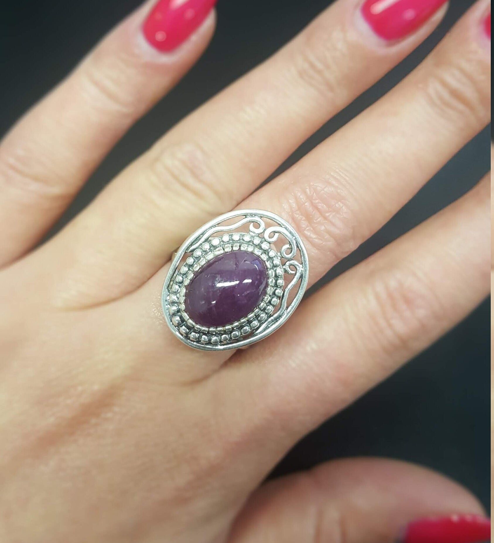Elegant 925 Sterling Silver ring featuring a stunning oval red ruby in a halo setting, perfect for special occasions.