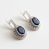 Created Sapphire Earrings made in 925 Sterling Silver with Oval Created Blue Sapphire in Prong setting, September Birthstone gift idea, symbolizes sincerity, truth, and faithfulness, ideal for everyday wear and perfect for birthday gifting and special occasions.