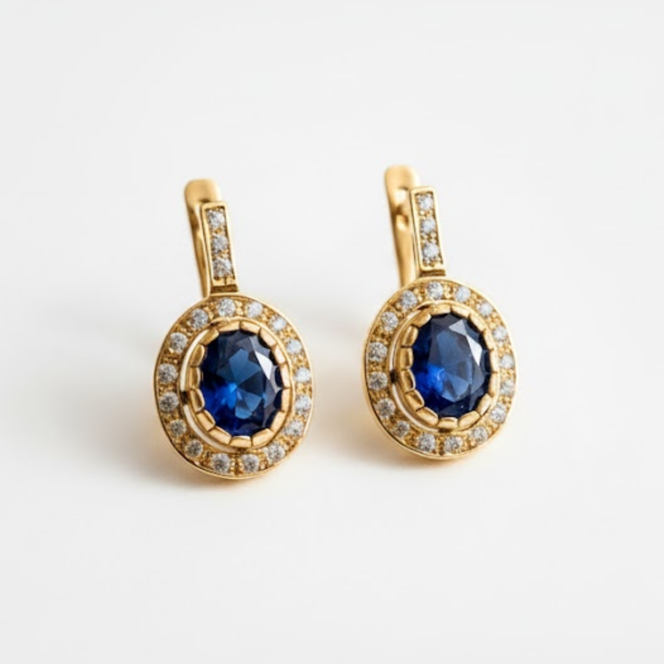 Created Sapphire Earrings made in 18k Gold Vermeil with Oval Created Blue Sapphire in Halo setting, September Birthstone gift idea, symbolizes sincerity, truth, and faithfulness, ideal for everyday wear and perfect for birthday gifting and special occasions.