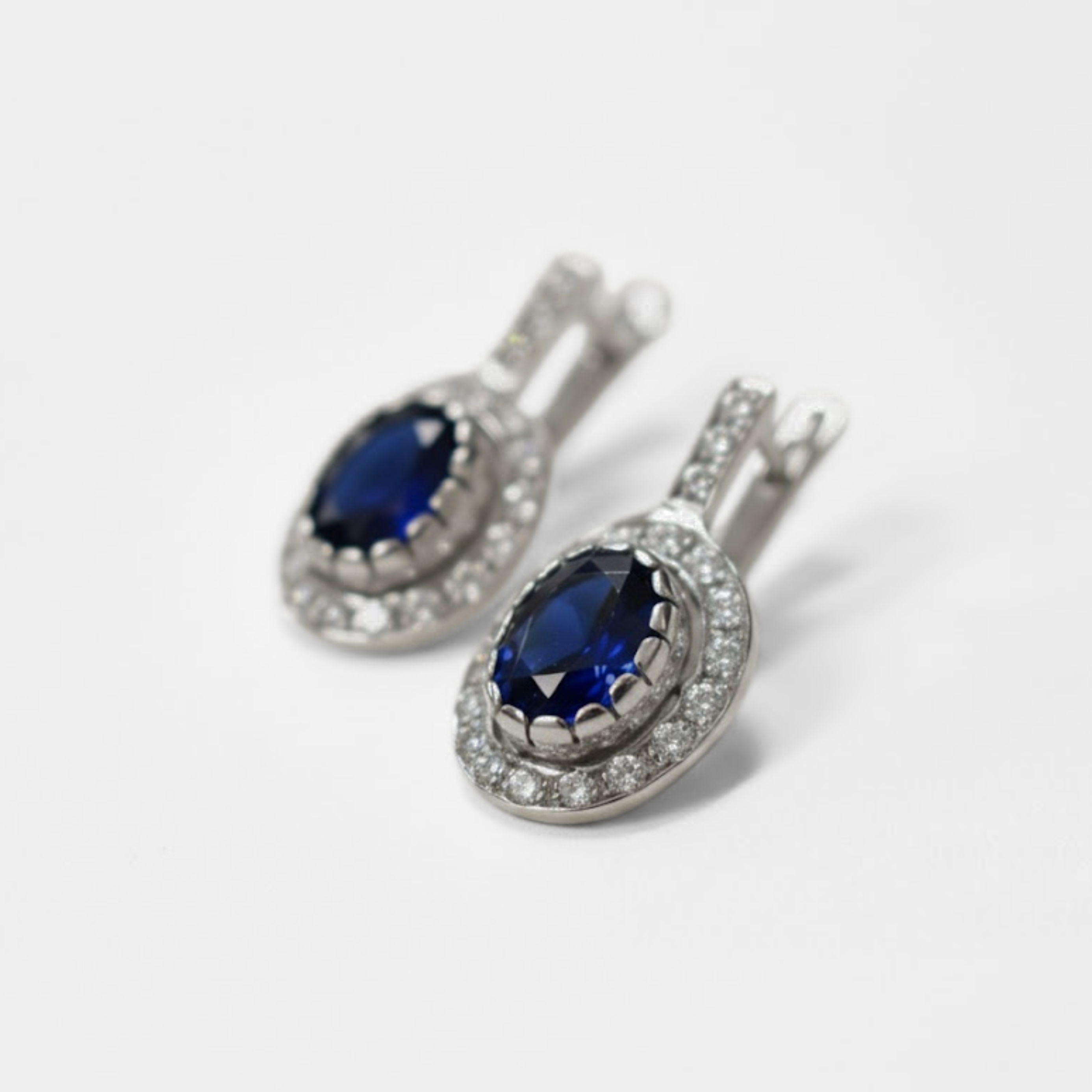 Stunning Oval Created Blue Sapphire Earrings in White Gold Vermeil, a meaningful gift for September birthdays and cherished moments.