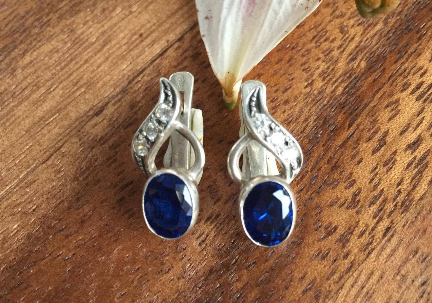 Created Sapphire Earrings made in 925 Sterling Silver with Oval Created Blue Sapphire in Bezel setting, September Birthstone gift idea, symbolizes sincerity, truth, and faithfulness, ideal for everyday wear and perfect for birthday gifting and special occasions.