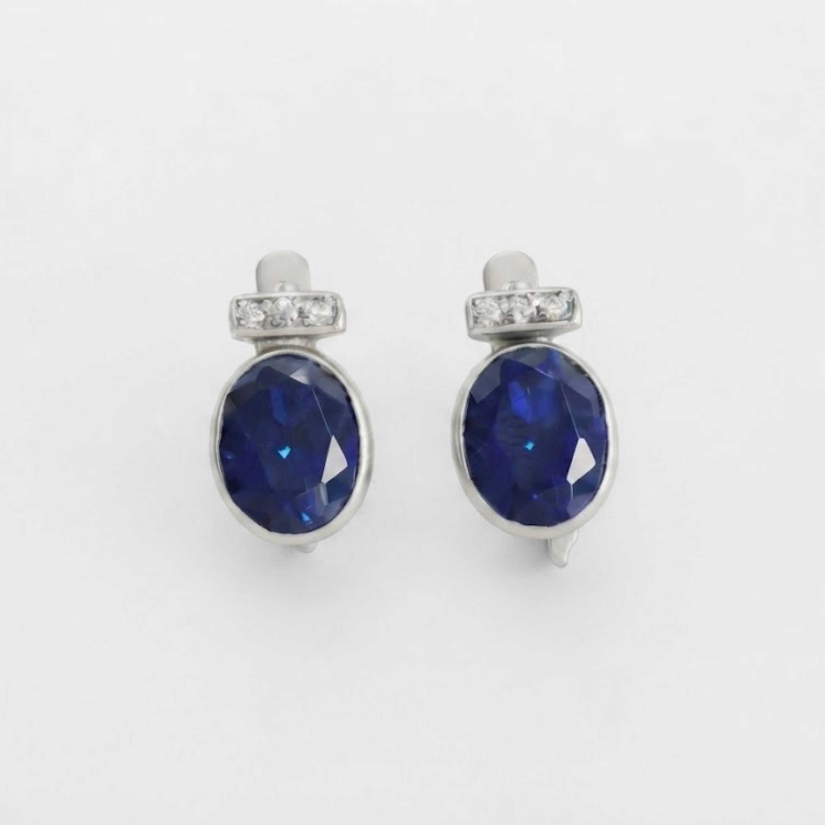 Created Sapphire Earrings made in 925 Sterling Silver with Oval Created Blue Sapphire in Bezel setting, September Birthstone gift idea, symbolizes sincerity, truth, and faithfulness, ideal for everyday wear and perfect for birthday gifting and special occasions.