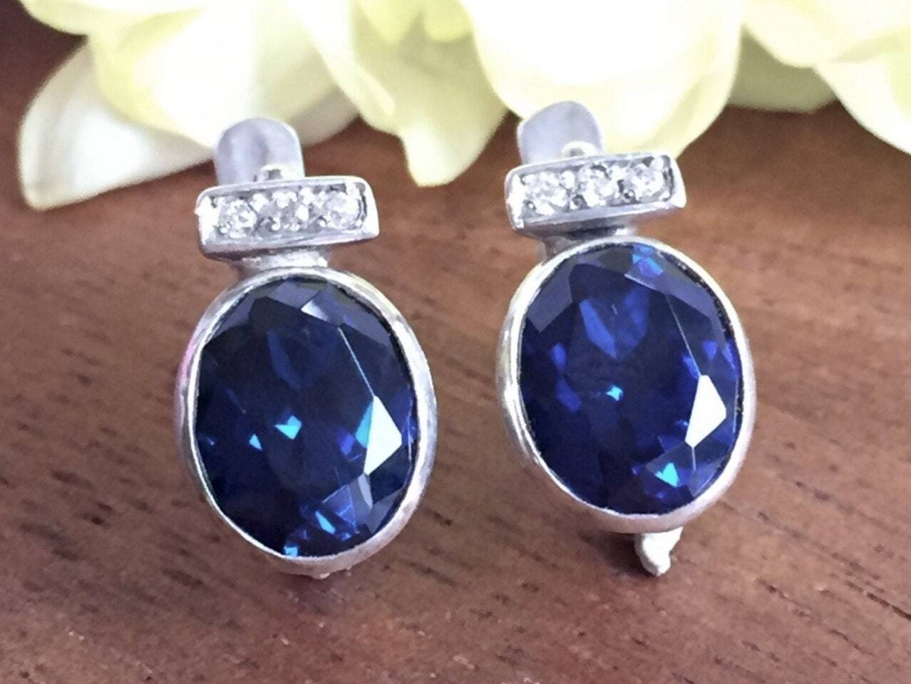 Created Sapphire Earrings made in 925 Sterling Silver with Oval Created Blue Sapphire in Bezel setting, September Birthstone gift idea, symbolizes sincerity, truth, and faithfulness, ideal for everyday wear and perfect for birthday gifting and special occasions.