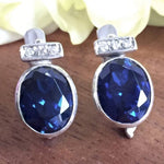 Created Sapphire Earrings made in 925 Sterling Silver with Oval Created Blue Sapphire in Bezel setting, September Birthstone gift idea, symbolizes sincerity, truth, and faithfulness, ideal for everyday wear and perfect for birthday gifting and special occasions.