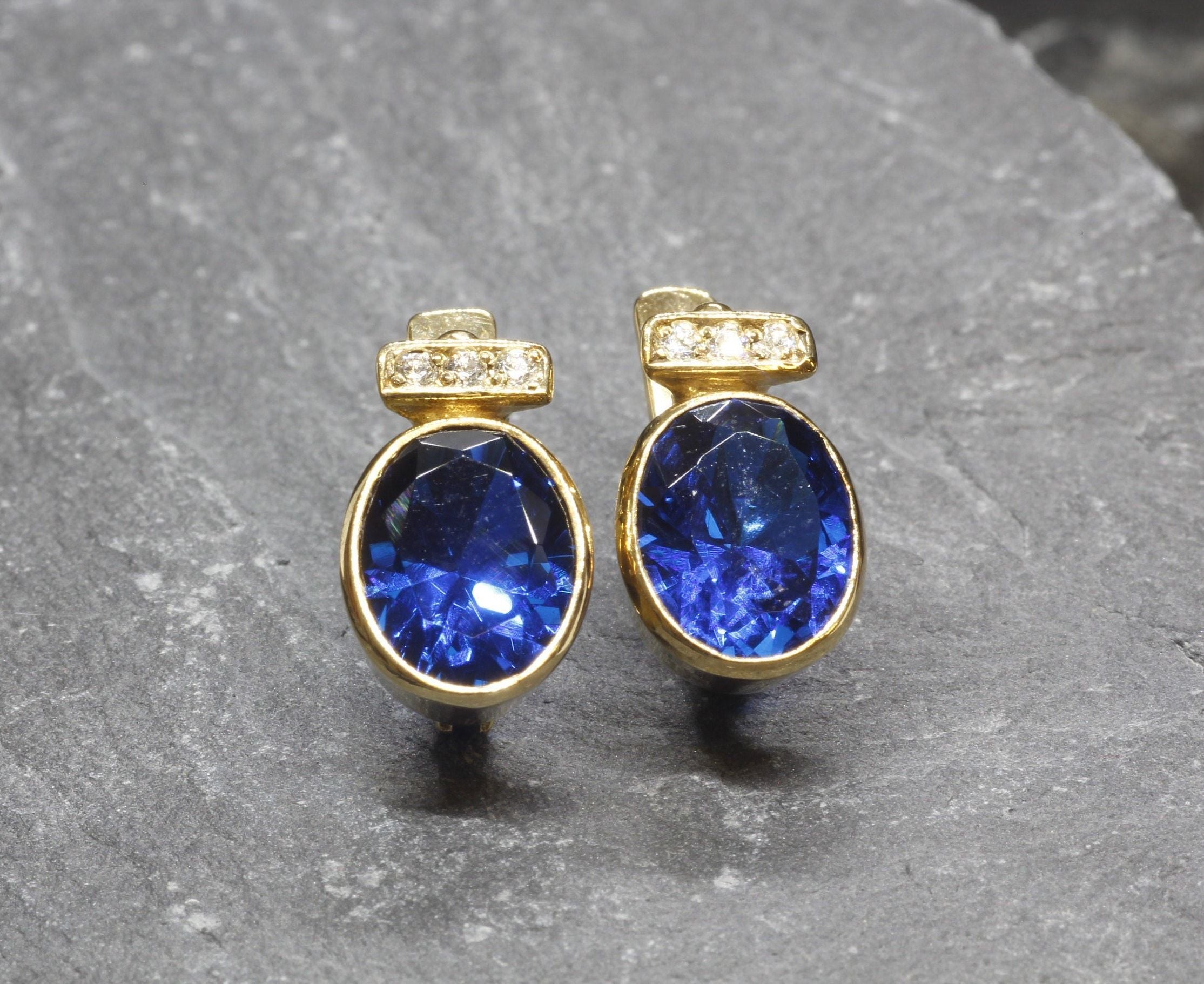 Created Sapphire Earrings made in 18k Gold Vermeil with Oval Created Blue Sapphire in Bezel setting, September Birthstone gift idea, symbolizes sincerity, truth, and faithfulness, ideal for everyday wear and perfect for birthday gifting and special occasions.