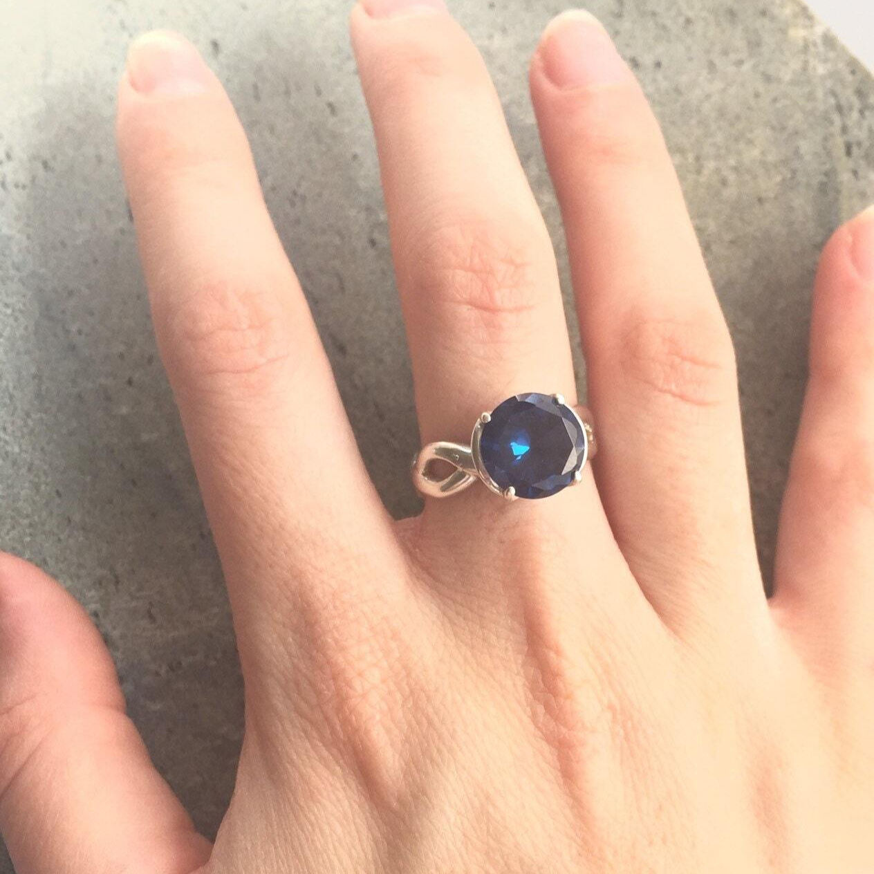Created Sapphire Ring in 925 Sterling Silver, featuring a round blue sapphire, perfect for September birthdays and special occasions.