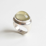 A close-up of a handcrafted gemstone ring featuring intricate details and a sparkling finish, showcasing its unique design.