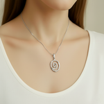 Silver Spiral Necklace displayed elegantly, showcasing its unique design and shine, perfect for any special occasion.