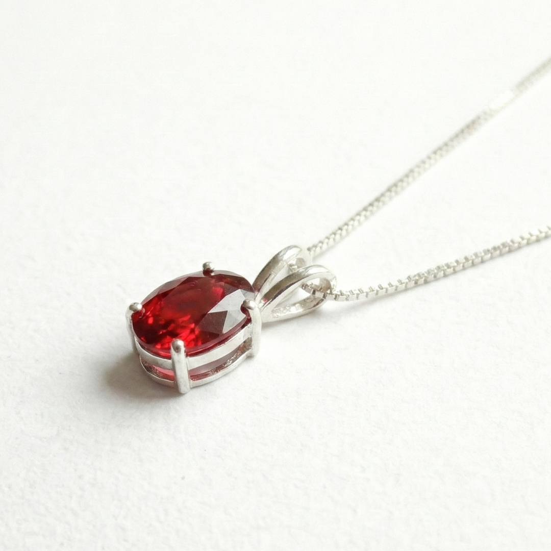 Beautifully crafted Ruby Pendant in 925 Sterling Silver, featuring an oval Created Red Ruby, perfect for special celebrations.