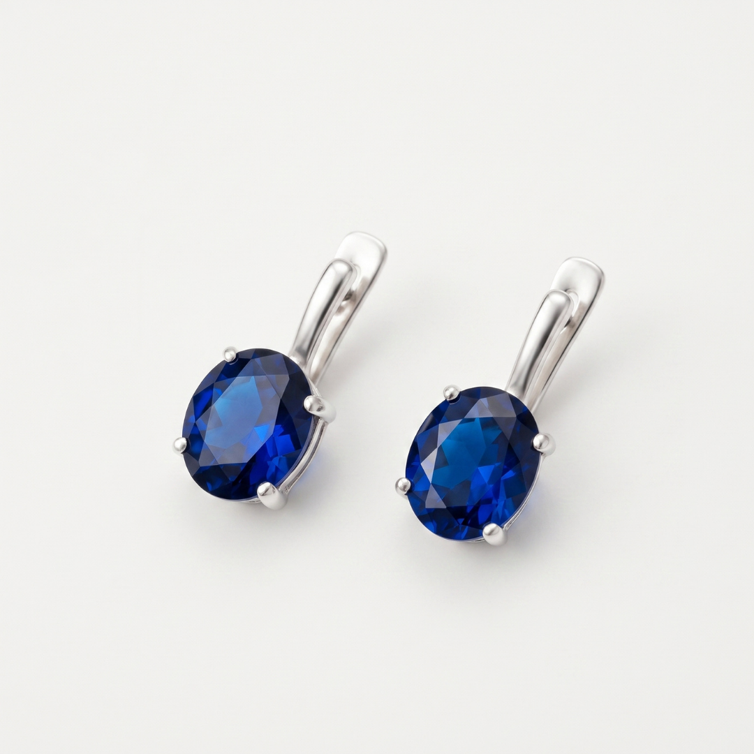 Created Sapphire Earrings made in 925 Sterling Silver with Oval Created Blue Sapphire in Prong setting, September Birthstone gift idea, symbolizes sincerity, truth, and faithfulness, ideal for everyday wear and perfect for birthday gifting and special occasions.