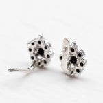 Sapphire Flower Earrings - Delicate blue floral studs in sterling silver, perfect for adding a touch of charm to any outfit.