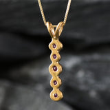 Exquisite 18k Gold Vermeil pendant showcasing a rich red ruby, perfect for daily wear and celebrating your loved ones' special days.