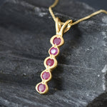 Beautiful 18k gold vermeil pendant with a round natural ruby, symbolizing love and making a thoughtful gift for July celebrations.