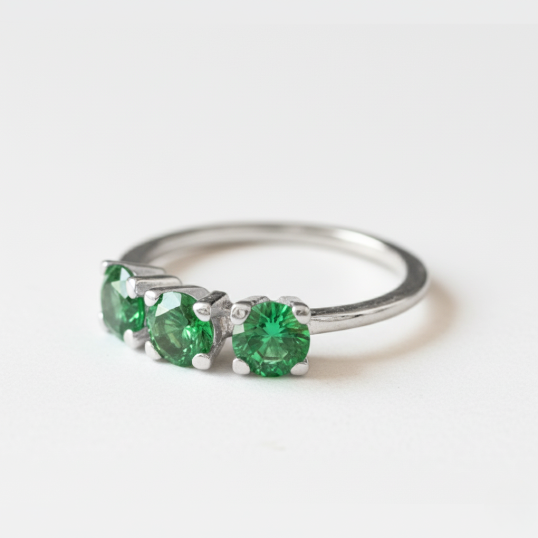Lustrous 925 Sterling Silver ring adorned with a Round Created Green Emerald in a timeless Three-Stone setting—May birthstone treasure.