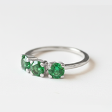 Lustrous 925 Sterling Silver ring adorned with a Round Created Green Emerald in a timeless Three-Stone setting—May birthstone treasure.