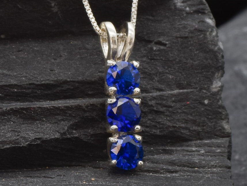 Created Sapphire Pendant made in 925 Sterling Silver with Round Created Blue Sapphire in Three-Stone setting, September Birthstone gift idea, symbolizes sincerity, truth, and faithfulness, ideal for everyday wear and perfect for birthday gifting and special occasions.