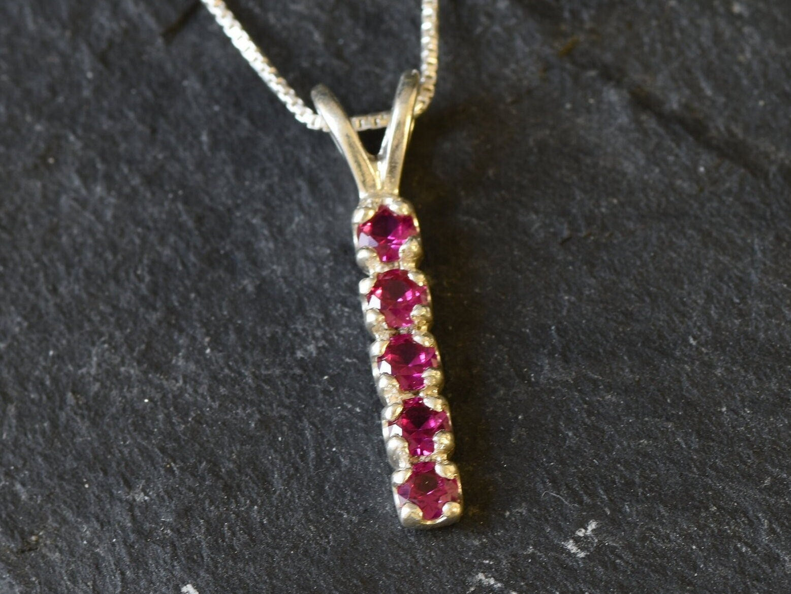 Created Ruby Pendant made in 925 Sterling Silver with Round Created Red Ruby in Channel-Set setting, July Birthstone gift idea, symbolizes nobility, purity, and passion, ideal for everyday wear and perfect for birthday gifting and special occasions.