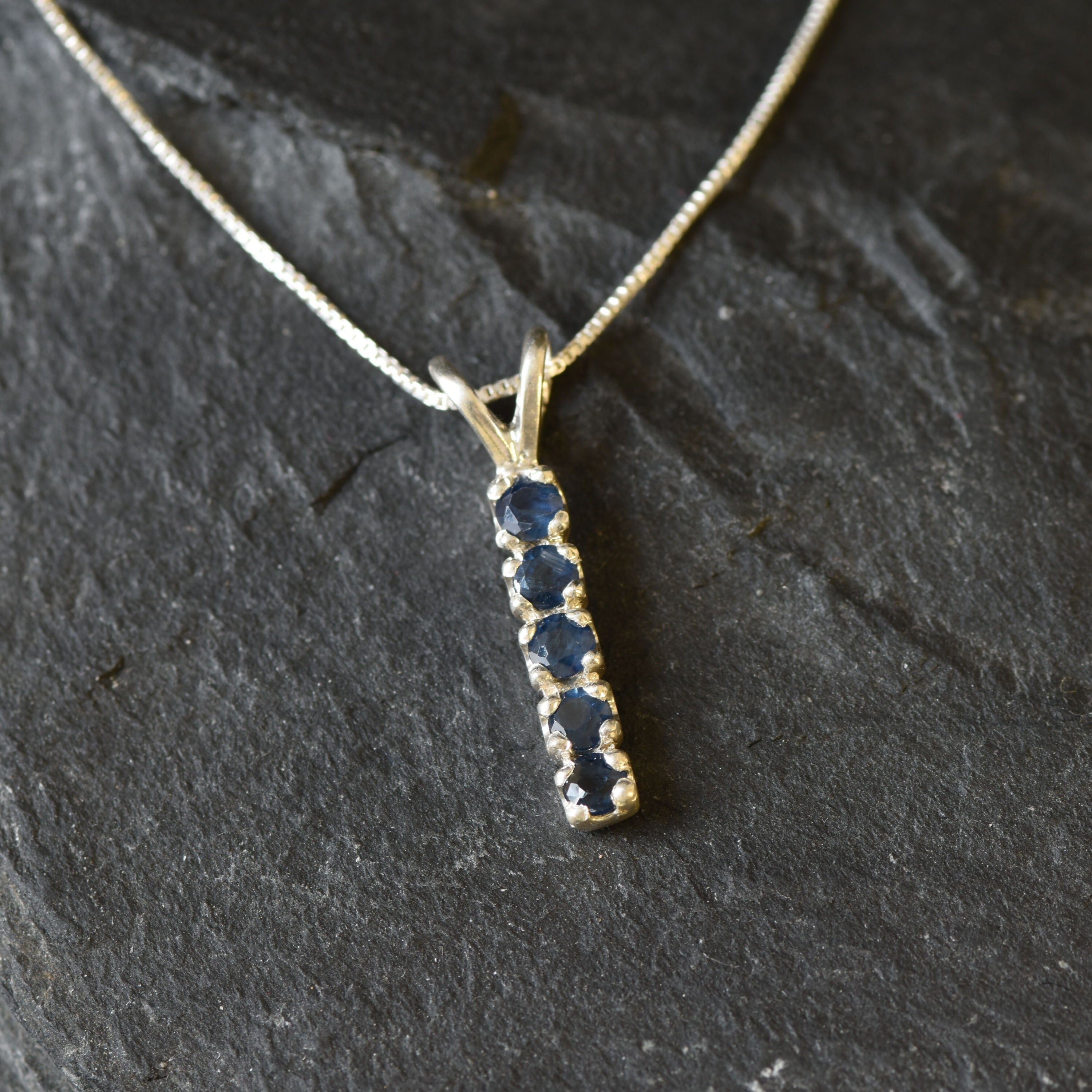 Channel-set created sapphire pendant in 925 sterling silver, September birthstone; a symbol of sincerity and faithfulness.