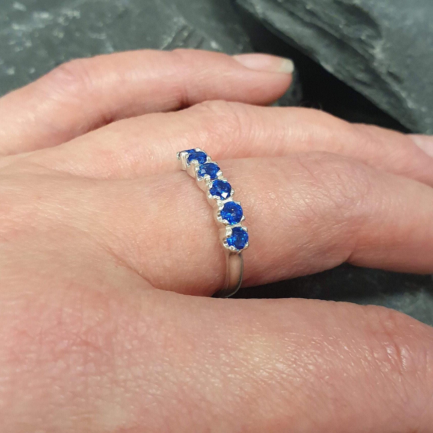 Channel-set sapphire ring in 925 sterling silver, a stunning September birthstone gift symbolizing sincerity and faithfulness.