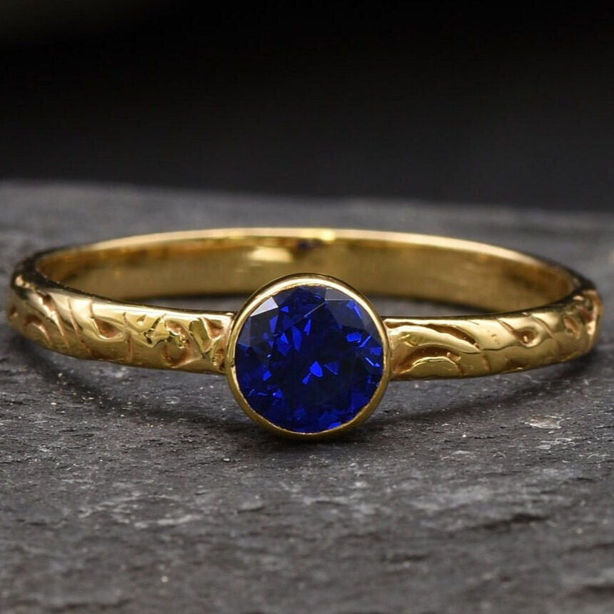 Stunning 18k Gold Vermeil Ring adorned with a bezel-set Created Blue Sapphire; ideal September gift for cherished moments.