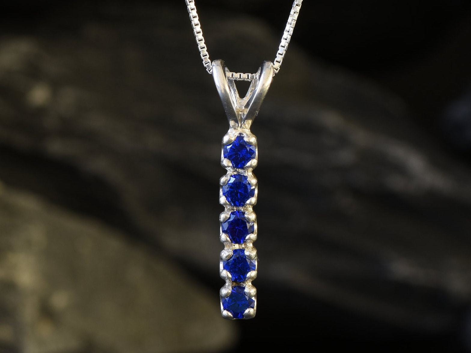 Created Sapphire Pendant made in 925 Sterling Silver with Round Created Blue Sapphire in Channel-Set setting, September Birthstone gift idea, symbolizes sincerity, truth, and faithfulness, ideal for everyday wear and perfect for birthday gifting and special occasions.