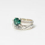 Elegant created emerald ring in sterling silver, showcasing a round green gem, ideal for special occasions and May birthdays.