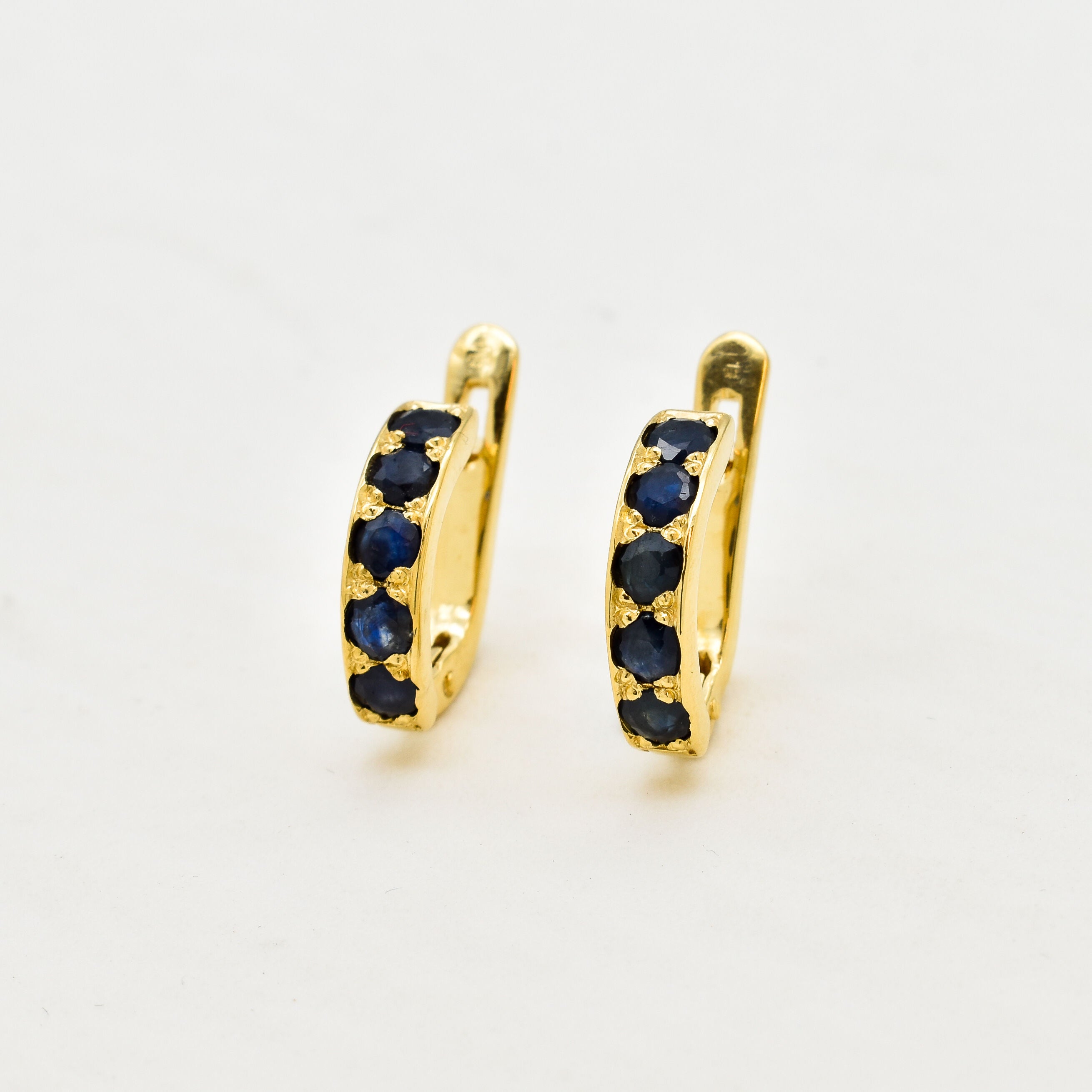 Gold Sapphire Huggies - Gold Hoop Earrings - Dainty Blue Hoops made in 18k Gold Vermeil. Ideal for everyday wear and perfect for birthday gifting and special occasions.