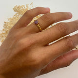 Charming 18k Gold Vermeil ring with a radiant round ruby, perfect for adding elegance to any outfit or special occasion.
