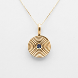 18k gold vermeil coin pendant featuring a spiral blue sapphire on a dainty chain, ideal September birthday jewelry