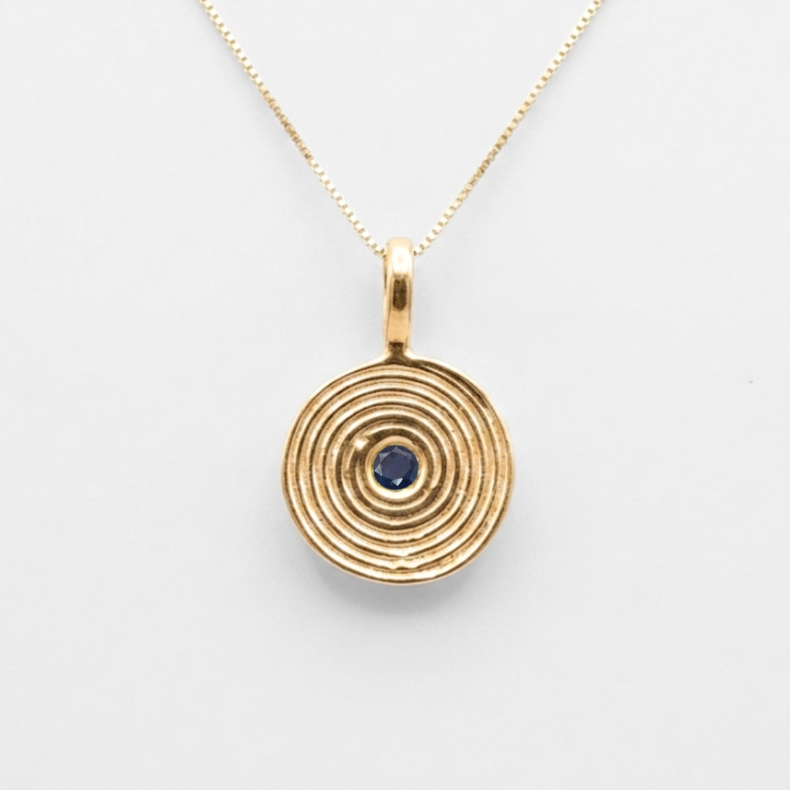 18k gold vermeil coin pendant featuring a spiral blue sapphire on a dainty chain, ideal September birthday jewelry