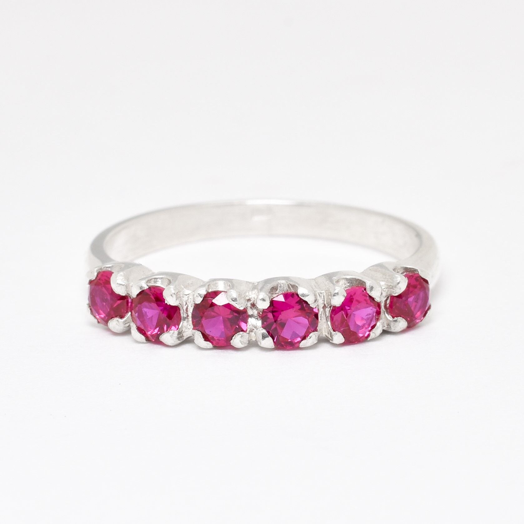 Channel-set created ruby ring in 925 sterling silver, perfect for birthdays and special occasions. July birthstone symbolizing passion.