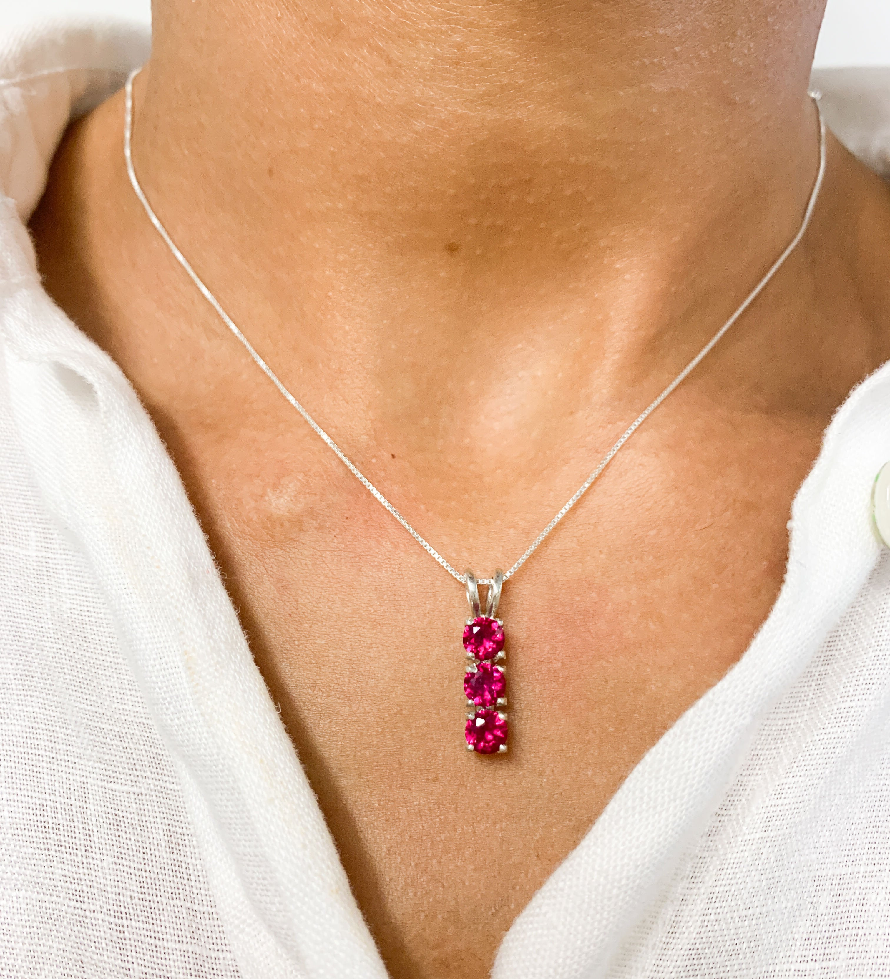 Created Ruby Pendant in 925 Sterling Silver with Three-Stone setting, perfect July birthstone gift for special occasions.