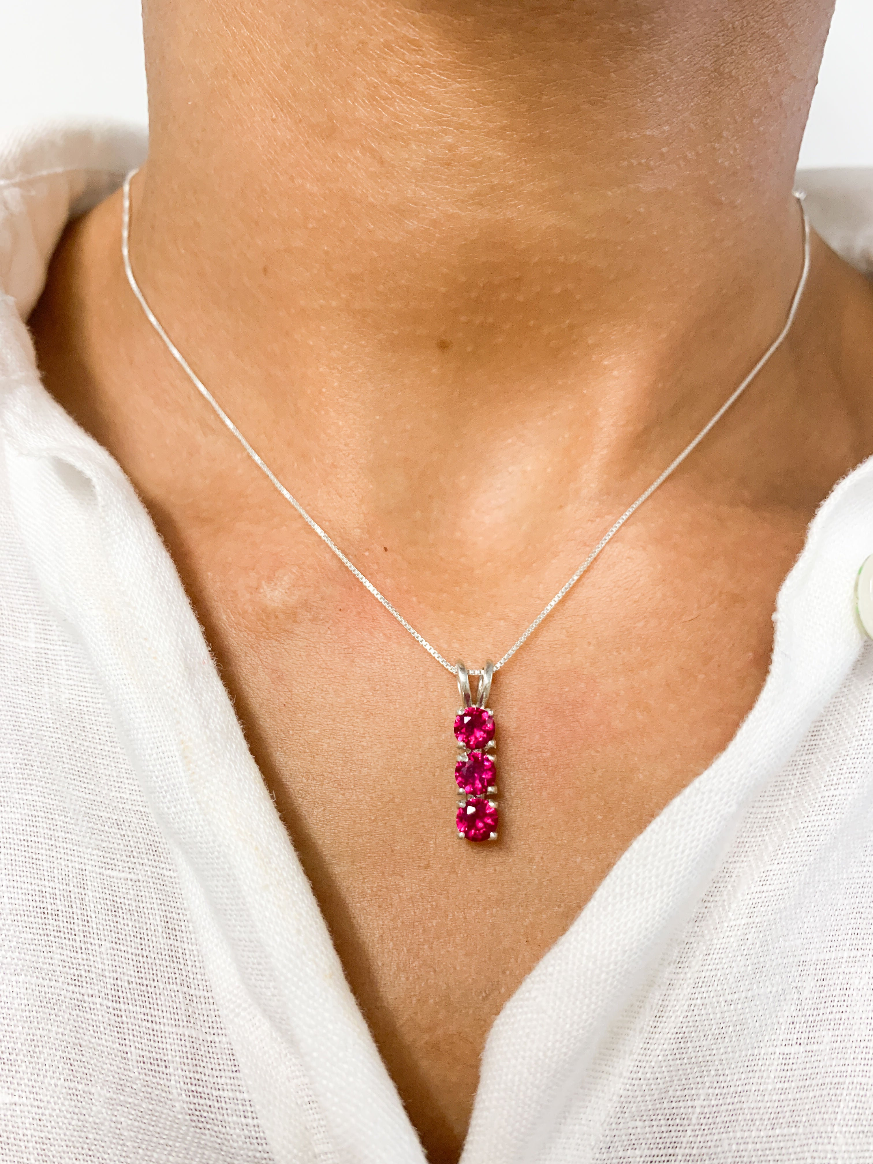Created Ruby Pendant in 925 Sterling Silver with Three-Stone setting, perfect July birthstone gift for special occasions.