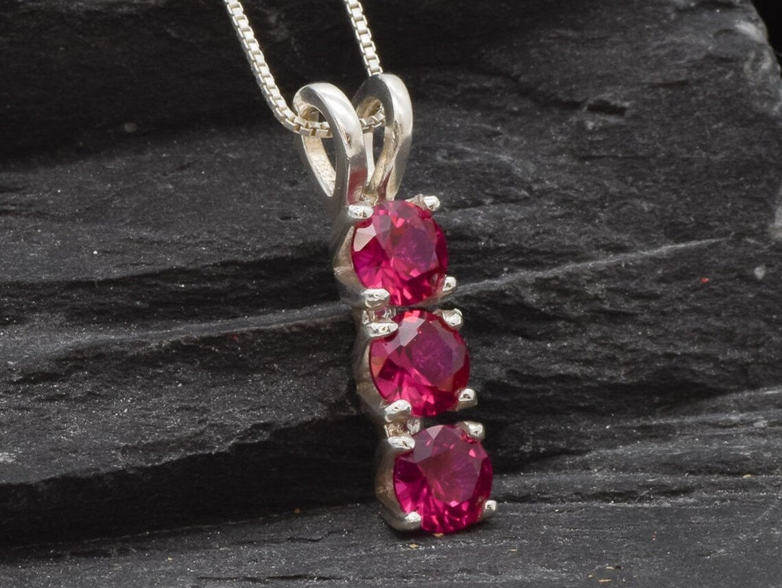 Elegant Created Ruby Pendant in 925 Sterling Silver, showcases a vibrant red stone, a meaningful gift for July birthdays.