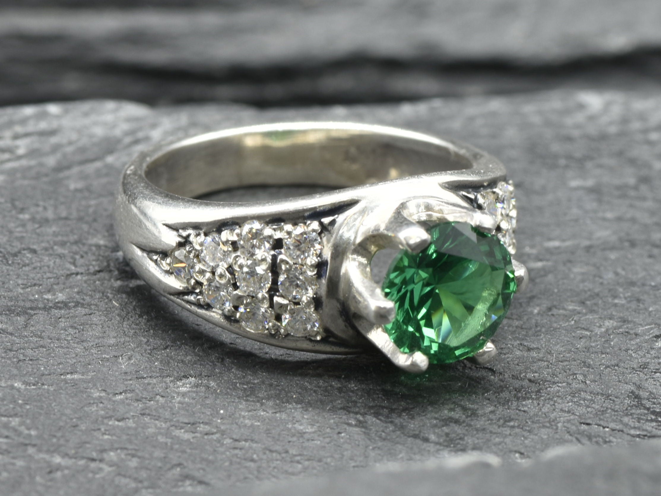 Stunning cluster ring in 925 Sterling Silver, adorned with a round created green emerald, perfect for May-born celebrations.
