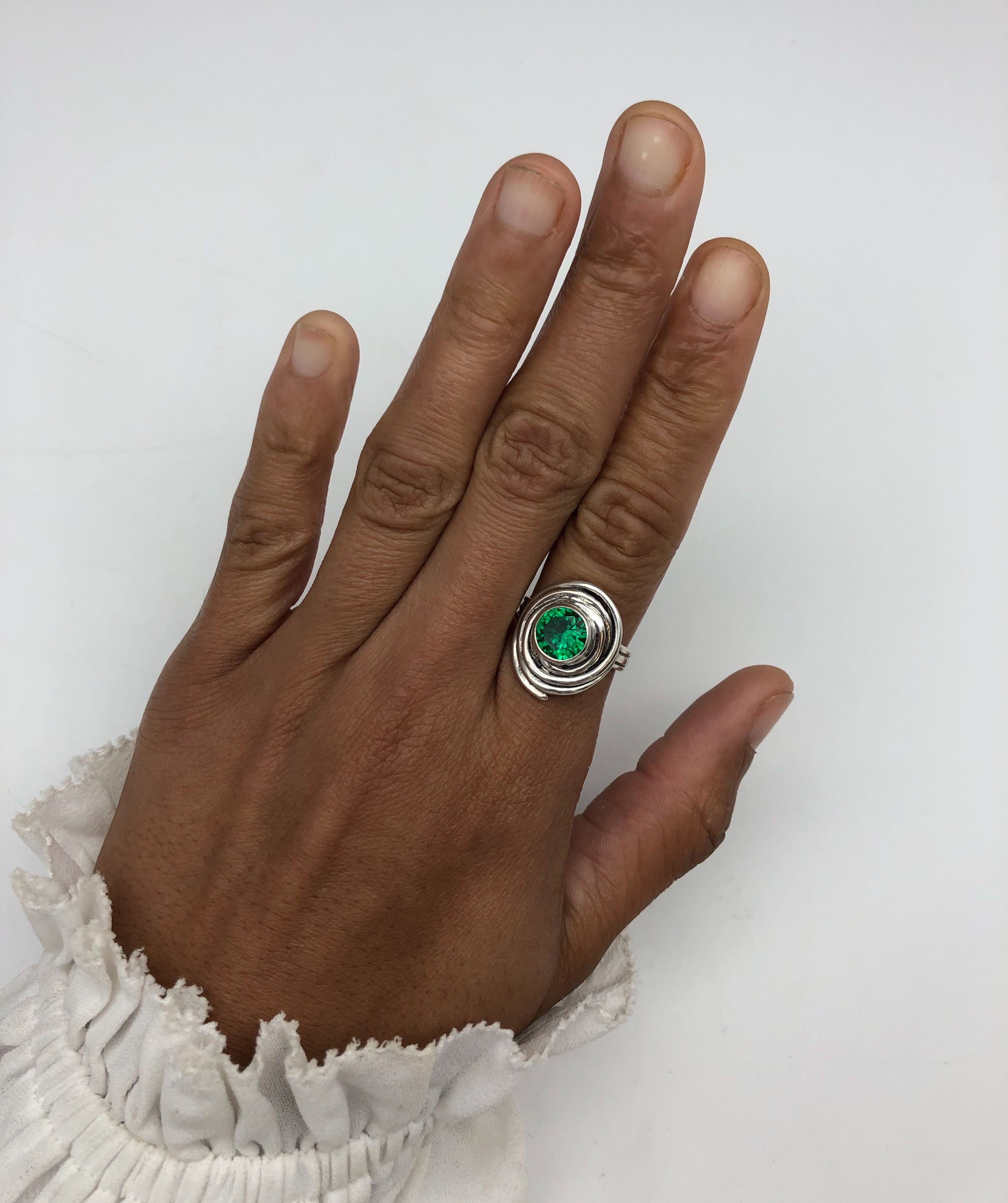 Beautiful 925 Sterling Silver ring adorned with a bezel-set Created Green Emerald, symbolizes love and prosperity, perfect for gifts.