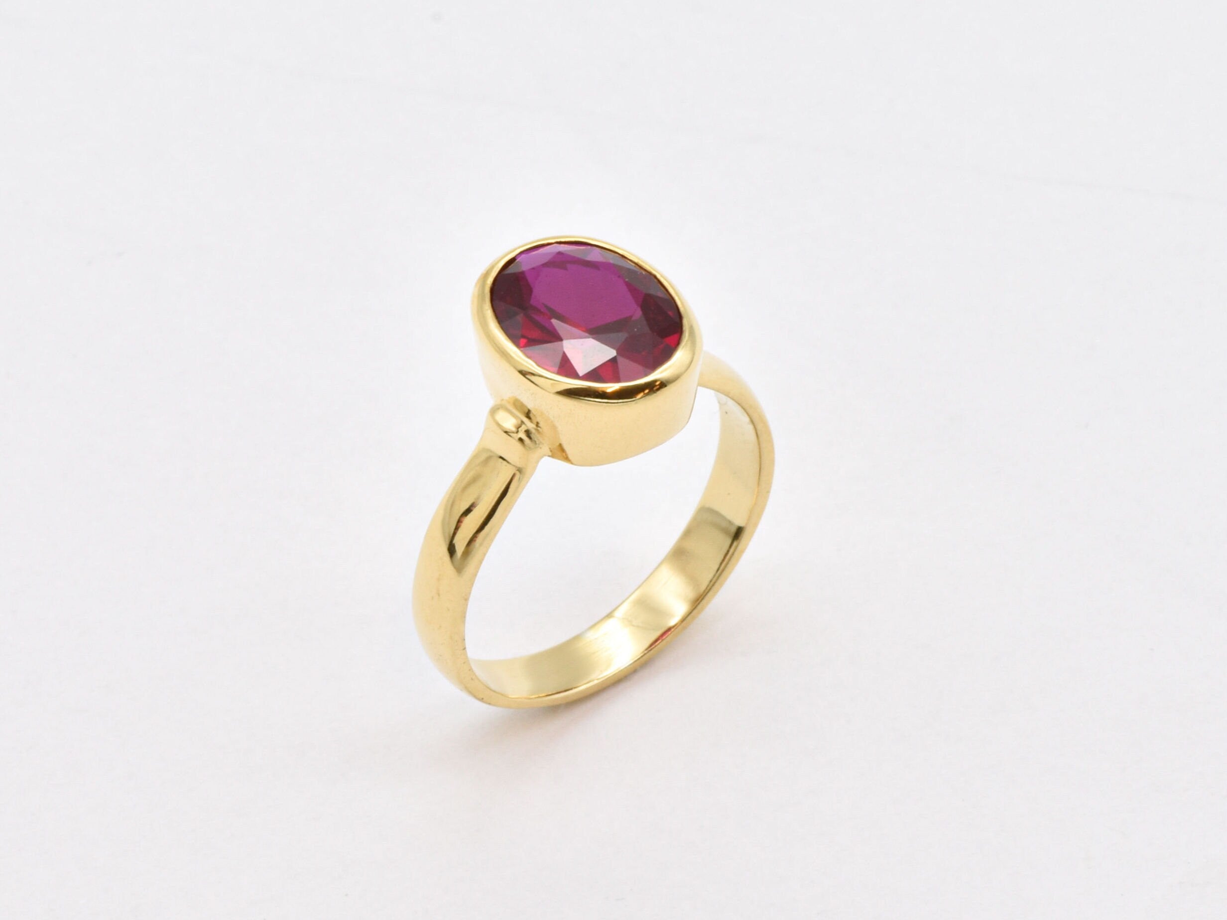 Elegant 18k gold vermeil ring featuring a sparkling oval created red ruby, perfect for birthdays and special occasions.