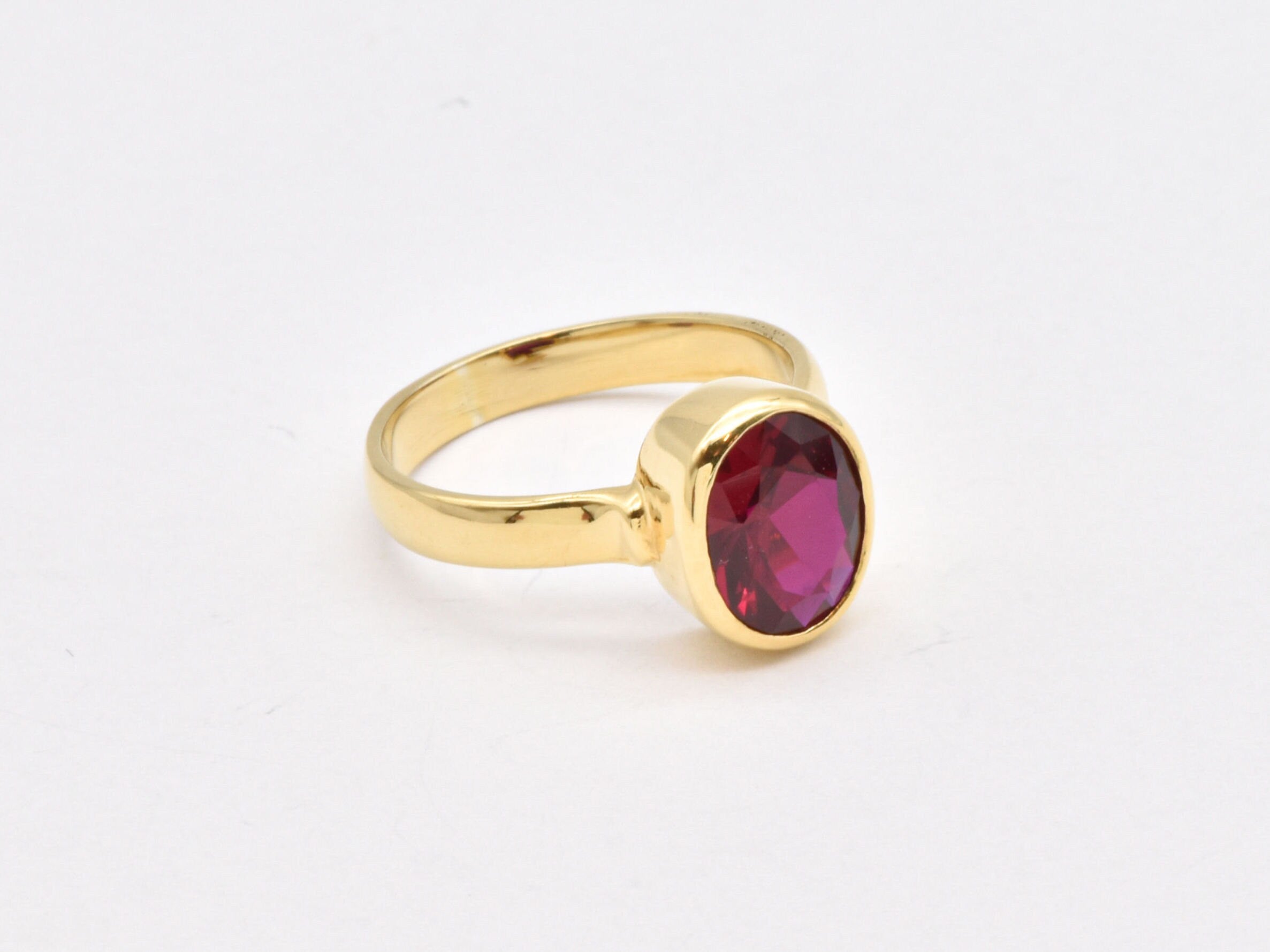 Beautiful 18k gold vermeil ring featuring a vibrant oval created red ruby, an ideal gift for July birthdays and elegant wear.