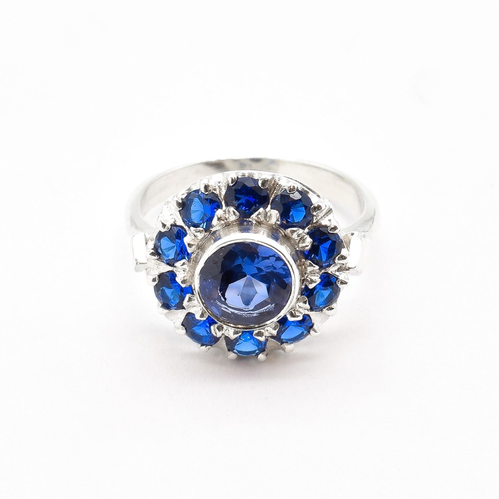 925 Sterling Silver Halo Ring set with a Round Created Blue Sapphire, ideal for birthdays and special celebrations.