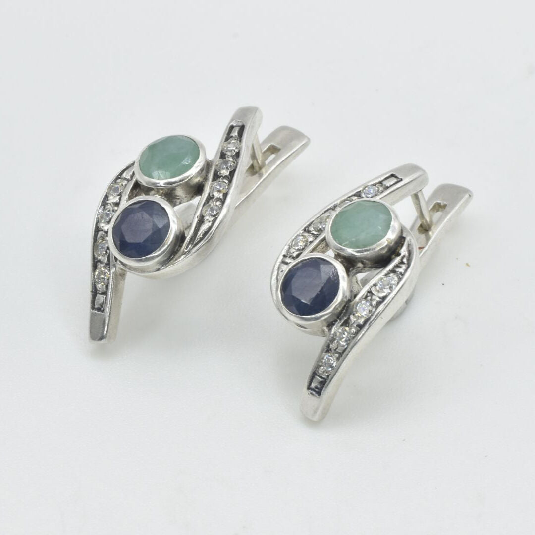 A bustling city street during sunset, with cars and pedestrians creating a vibrant urban atmosphere.