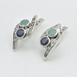 A bustling city street during sunset, with cars and pedestrians creating a vibrant urban atmosphere.